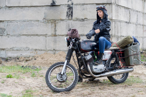 istock A post apocalyptic woman on motorcycle near the destroyed building 967129082