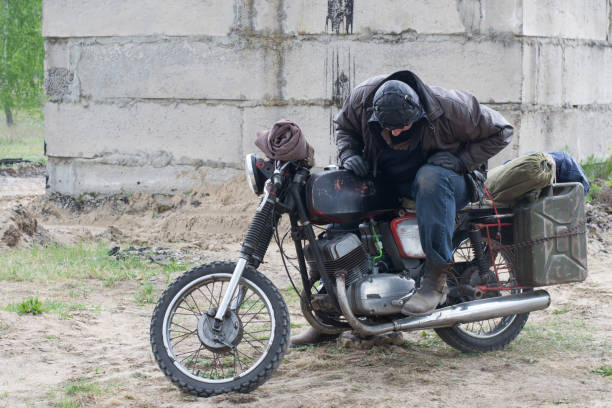 istock A post apocalyptic man on motorcycle near the destroyed building 967129328