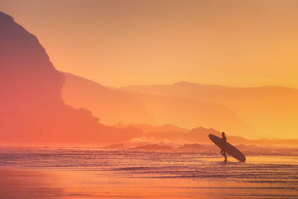 istock surfer silhouette at the sunset 967129692