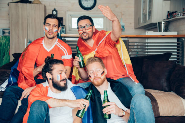 istock Friends drinking beer and watching soccer from home 967129988