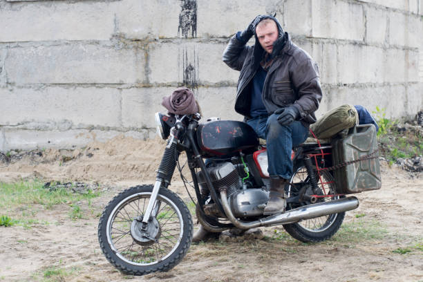 istock A post apocalyptic man on motorcycle near the destroyed building 967130752