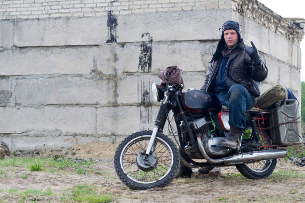 istock A post apocalyptic man on motorcycle near the destroyed building 967133200
