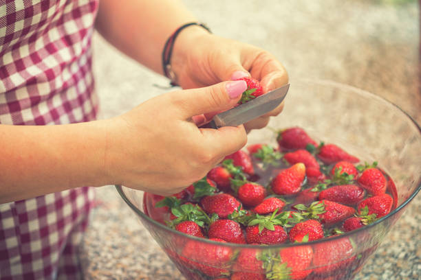 istock Washing strawberries for making homemade jam 967133600