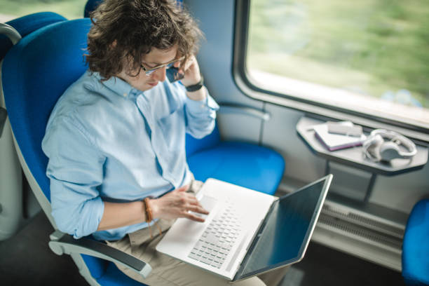 istock Businessman phone call in train 967138030