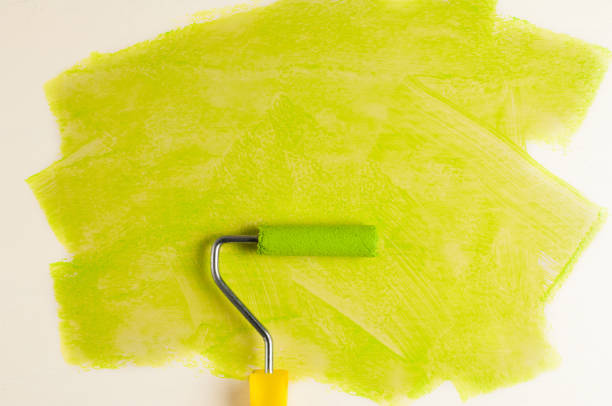 istock Roll for paint and green track on white wall. Repair concept 967142374