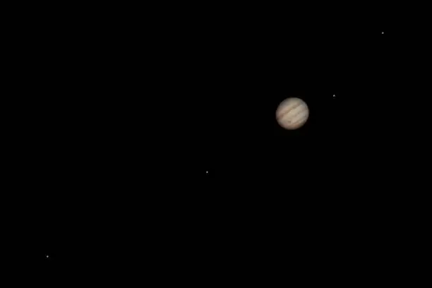 The giant planet Jupiter with its four Galilean moons Io, Europa, Ganymede, and Callisto as seen from the Odenwald in Germany.