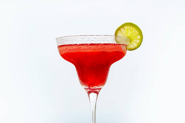 istock A glass with a red cocktail and lemon on a white background. 967167648