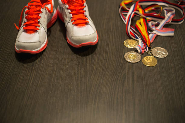 istock Running shoes  on a wooden floor background 967172032