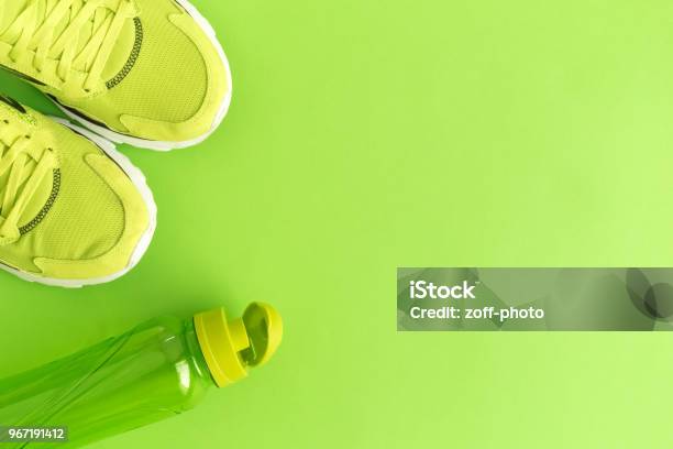 High Angle View Of Trainers And Bottle Stock Photo - Download Image Now - Backgrounds, Healthy Lifestyle, Green Color