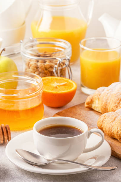 istock Continental breakfast with fresh croissants, orange juice and coffee, selective focuse. 967196986