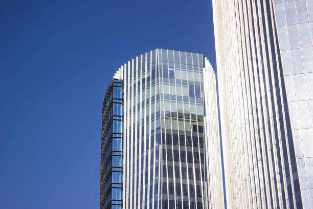 istock Blue corporate building with a frontal blue glass window wall. 967217192