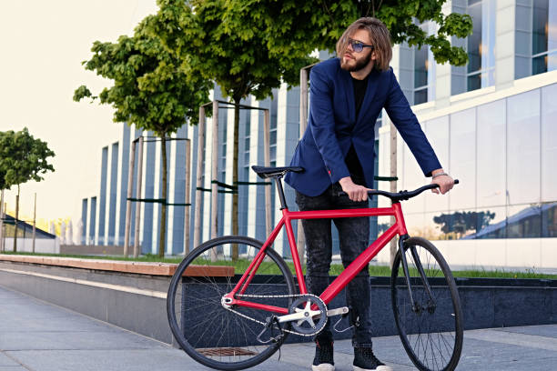 istock A man rides on a single speed bicycle and using a smart phone. 967219842