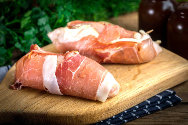 istock Raw chicken breast stuffed with champignon wrapped with bacon. 967220348