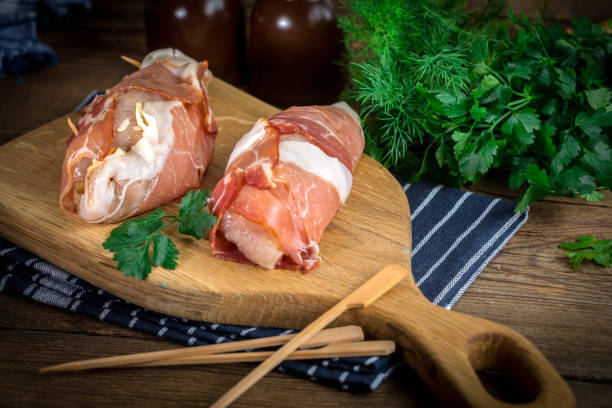 istock Raw chicken breast stuffed with champignon wrapped with bacon. 967220492