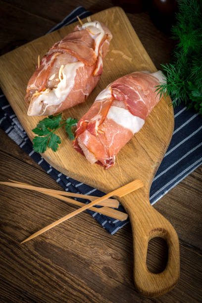 istock Raw chicken breast stuffed with champignon wrapped with bacon. 967220586