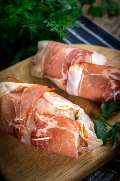 istock Raw chicken breast stuffed with champignon wrapped with bacon. 967220672