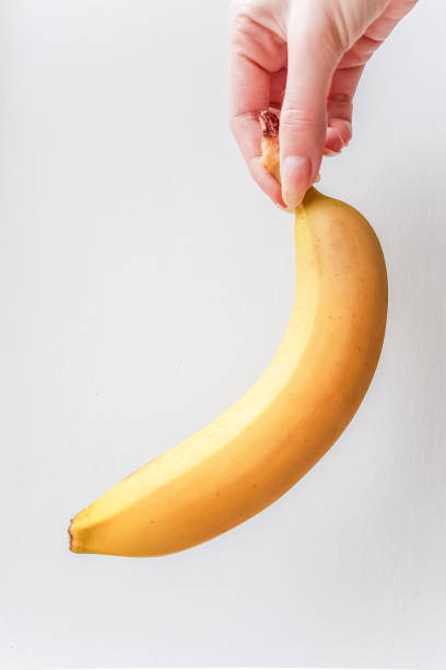 istock Ripe yellow banana in hand 967223254