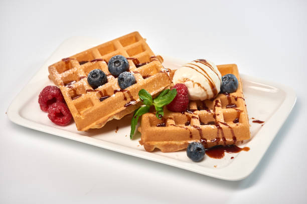 istock Belgian waffles with ice cream, blueberries and raspberries. 967242408
