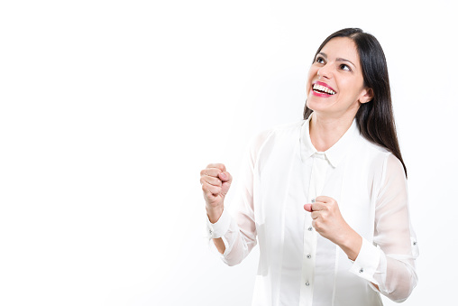 Young beautiful, brunette woman, business woman, Caucasian, with white shirt, smiling, happiness, celebrating, looking up, looking away, studio, empty area, isolated on white background