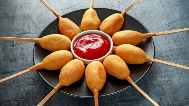 istock Mini Corn Dogs on black plate with ketchup 967255230