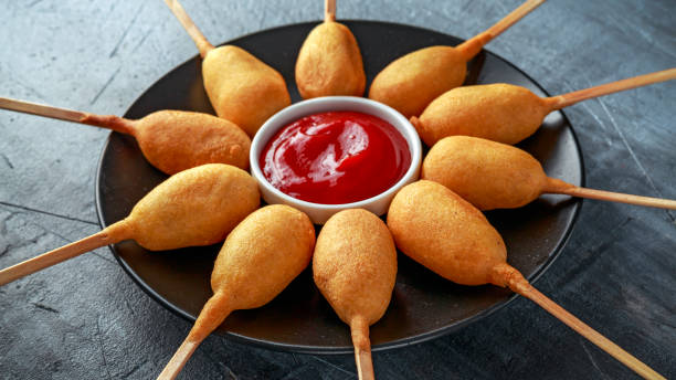 istock Mini Corn Dogs on black plate with ketchup 967255284