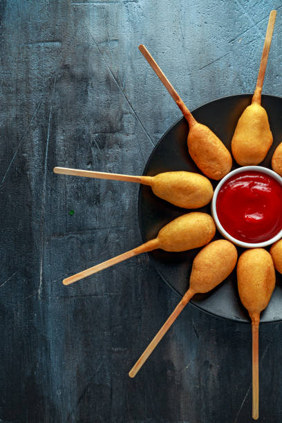 istock Mini Corn Dogs on black plate with ketchup 967255406