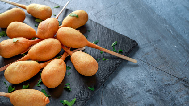 istock Mini Corn Dogs on stone platter with ketchup 967255438