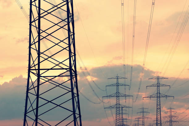 istock Electricity pylon silhouettes at sunset in Germany 967260712
