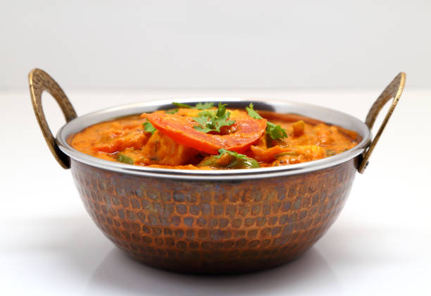 istock Indian Food or Indian Curry in a copper brass serving bowl. 967269444