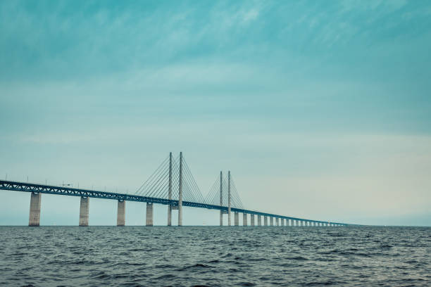 Aerial view of the Øresund Bridge with Denmark and Copenhagen in the far background just after sunset. The Oresund Bridge is connecting Denmark and Sweden.