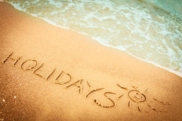 istock The word holidays written in the sand on a beach 967271700