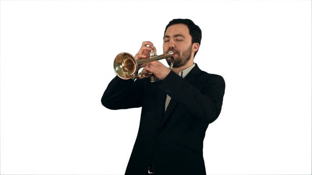 istock Young musician playing trumpet on white background isolated 967274610
