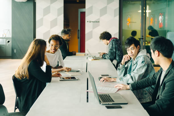 istock Young men and women discussing at the cafe. 967276112