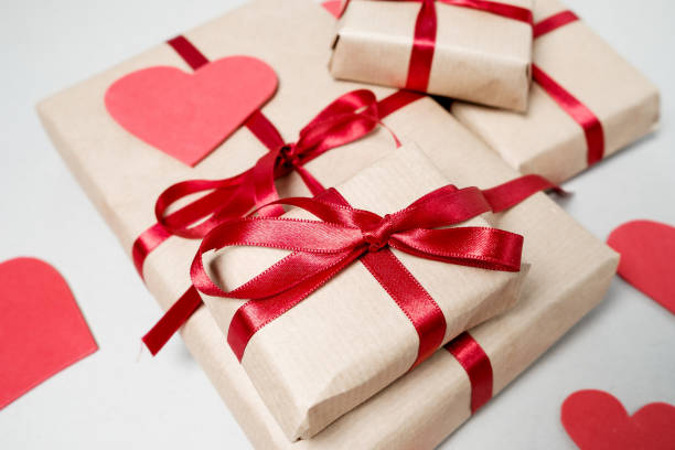 istock Valentine day background with gift boxes, red ribbon and hearts on white background. Top view, flat lay 967280168