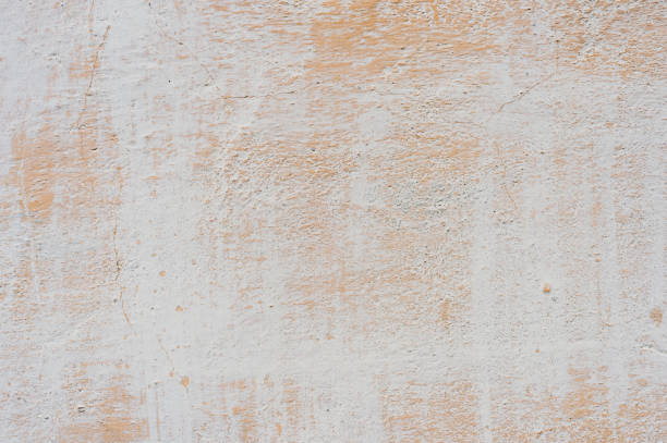 istock beige-white Textured background of multi-layer flaking paint on the wall. Grunge texture with a deep pattern 967296294