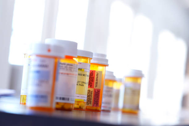istock Several Medication Pill Bottles On Table In Front Of Windows 967296308
