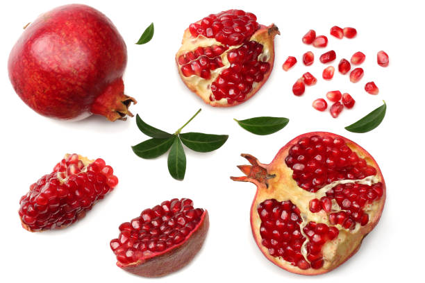 istock pomegranate fruit with seeds and green leaves isolated on white background top view 967300086