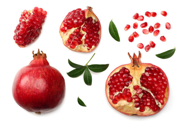istock pomegranate fruit with seeds and green leaves isolated on white background top view 967300088