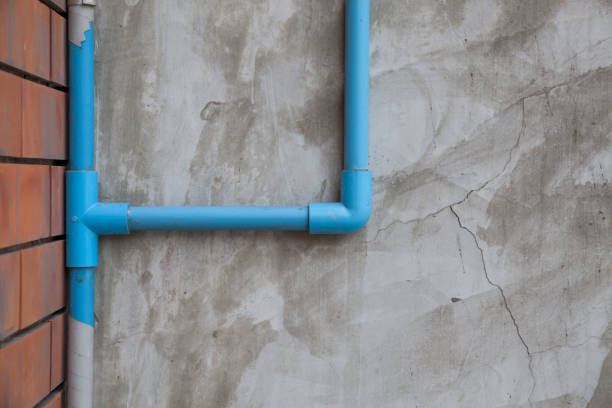 istock Blue water pipe On a polished concrete wall 967303744