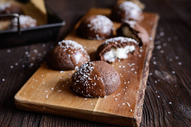 istock Cocoa biscuits with coconut filling, decorated with chocolate and grated coconut 967315198
