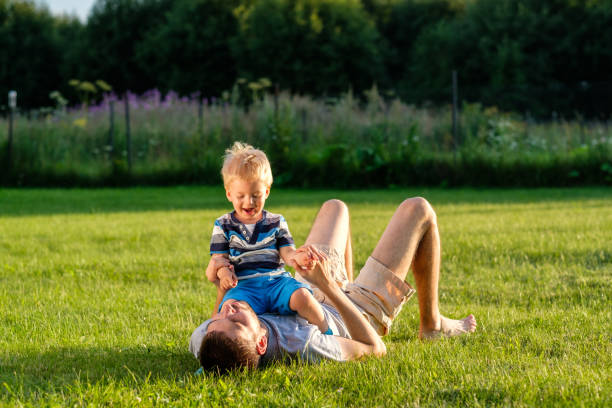 istock Happy father and son having fun outdoor on meadow 967318178