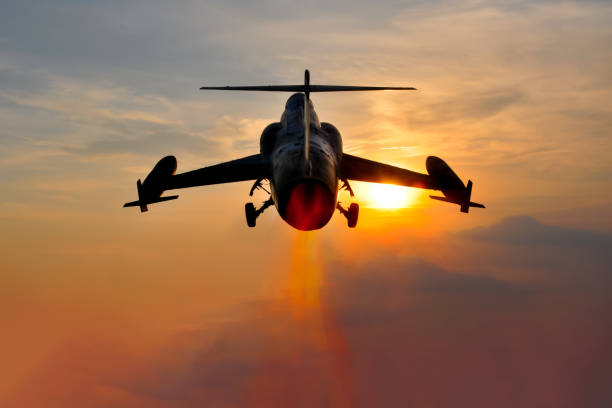 istock Night flight. Military Airplane in the sky at sunset 967326514