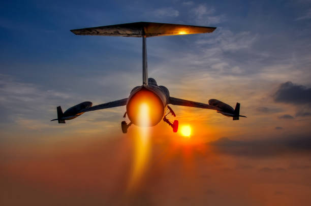 Night flight. Military Airplane in the sky at sunset