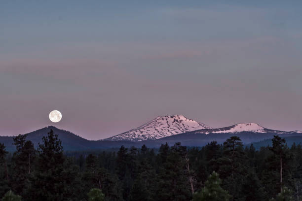 istock Full moon setting over Mount Bachelor in the Cascade Mountains in Central Oregon, USA 967330052