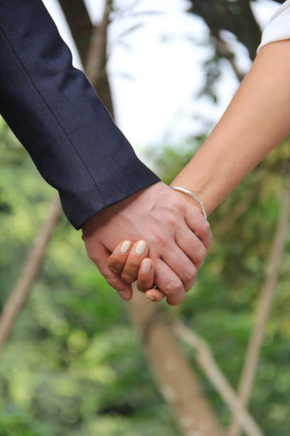 istock Man and wife holding hands 967338048