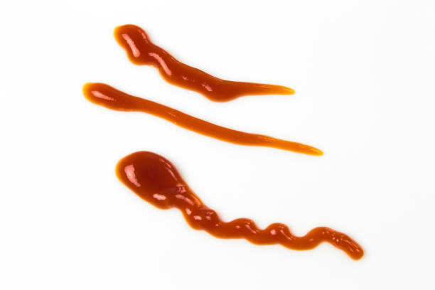istock Tomato sauce isolated on white background. Red ketchup splashes isolated on white background, top view 967358292