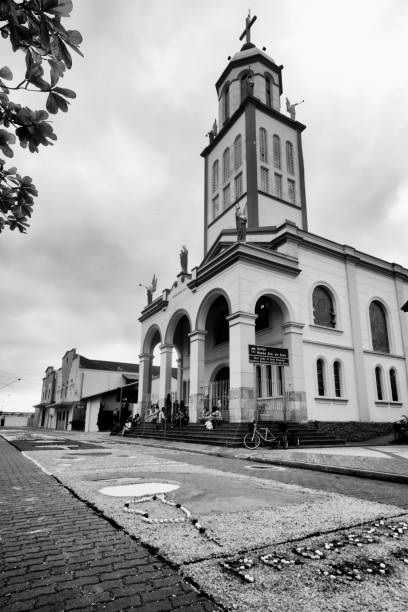 Itanhaém, SP, Brazil - May 10, 2018: Corpus Christi catholic procession over traditional carpets ridden by sawdust, eggshells, coffee powder and other colored materials