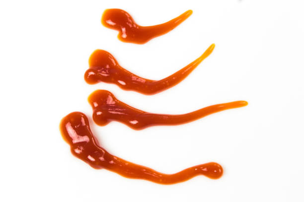 istock Tomato sauce isolated on white background. Red ketchup splashes isolated on white background, top view 967360642