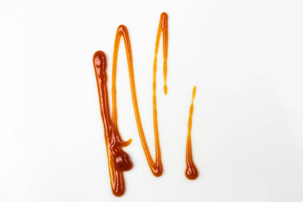 istock Tomato sauce isolated on white background. Red ketchup splashes isolated on white background, top view 967360694