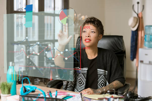 istock Woman in her Office Accessing Information from a Futuristic Financial Chart 967369510